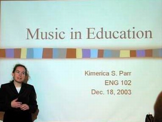 Student in front of PowerPoint presentation.